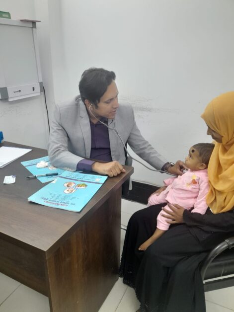 Dr. Shabbir Ahamed Bhuiyan caring a child at Konabari Popular Hospital, Gazipur