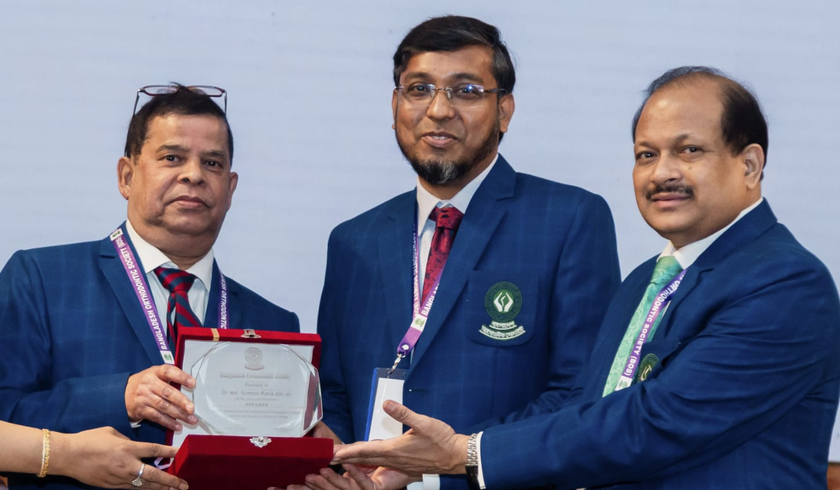 Dr. Md. Sumon Reza receiving an award plaque from senior dental professionals during a formal ceremony, wearing official conference attire