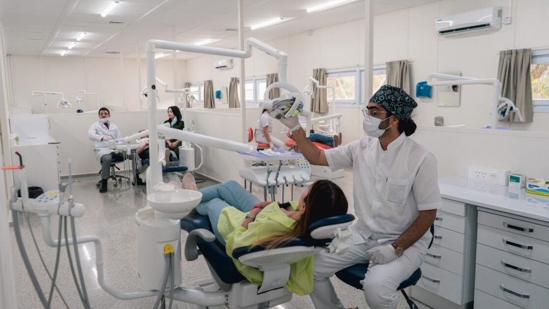 a dentist examines a Pediatric Dental's teeth in a dental office