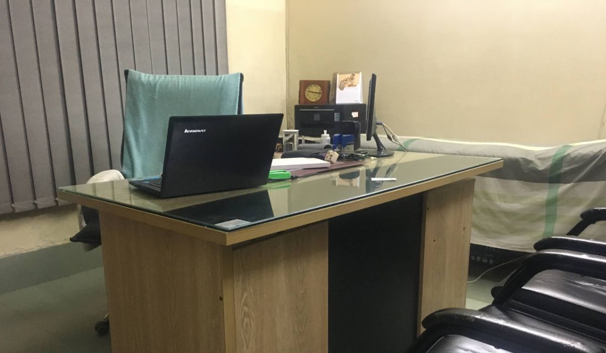 The consultation desk of Homeo Care, showing a laptop and office setup.
