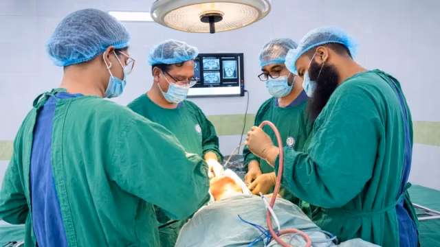 Oral cancer surgeons performing a surgical procedure in a Dhaka operating room